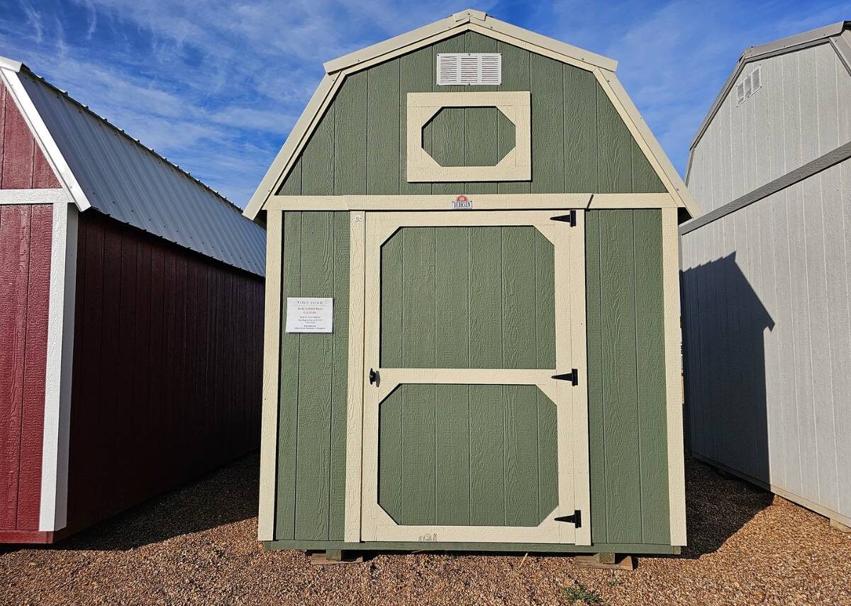 Green lofted barn and shed for sale at Tiny Hive in Giddings, TX