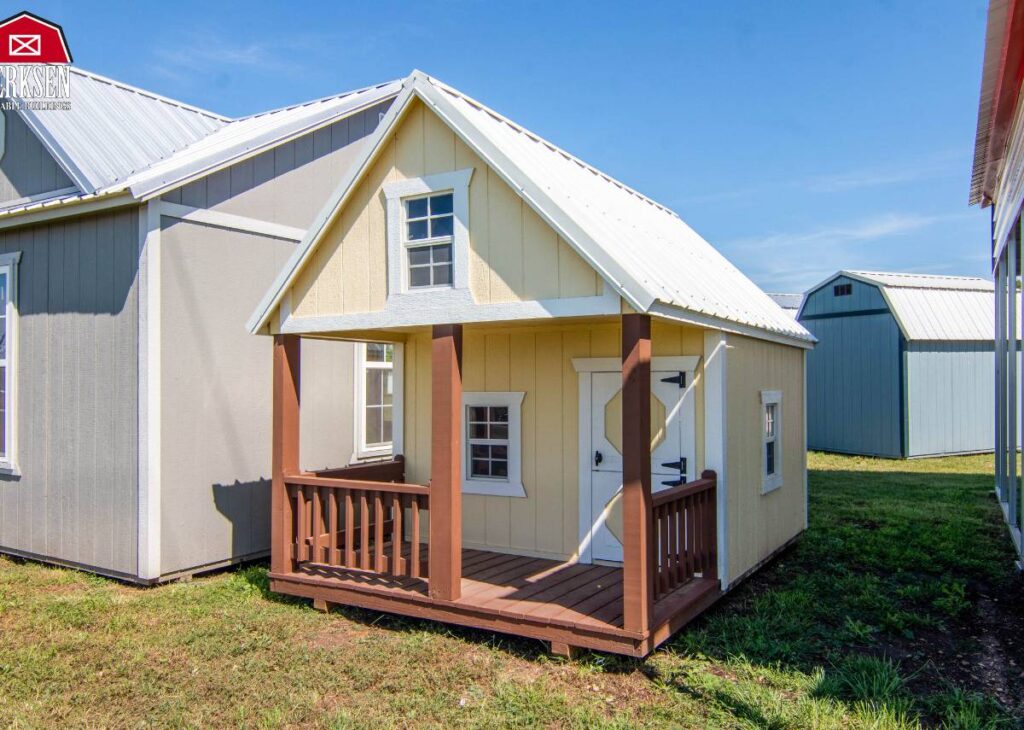 Yellow playhouse with porch at Tiny Hive in Giddings, TX
